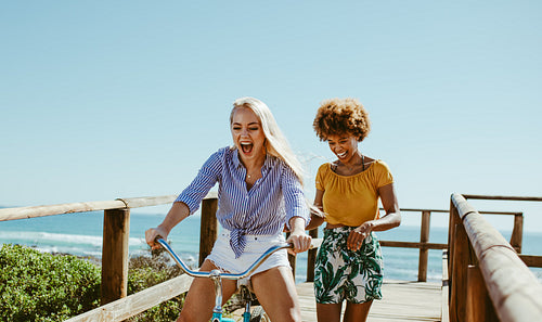 Cheerful friends having fun with a cycle