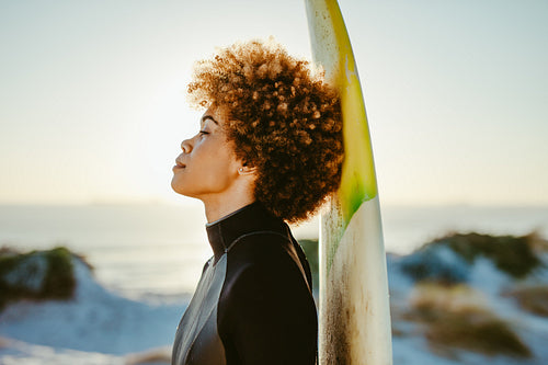 Woman resting after surfing