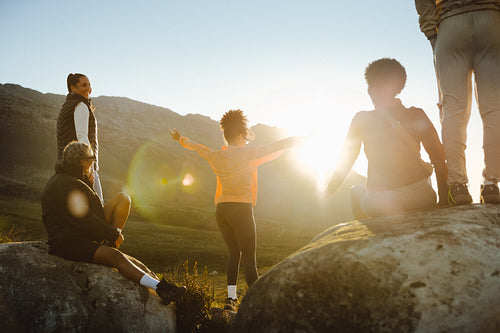 Group of friends hiking at sunset