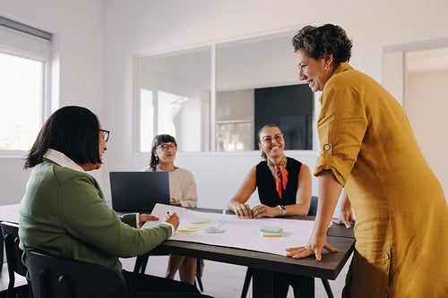 Joyful team brainstorming during a collaborative planning session in a casual workspace