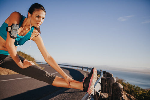 Woman stretching her legs before a run