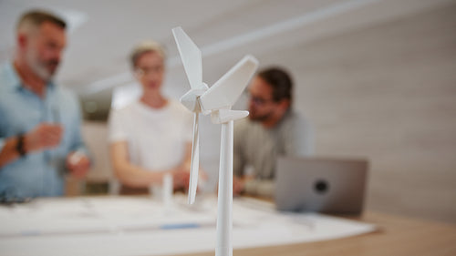 3D modeling for a wind energy project: Group of sustainable engineers working together on a windmill design