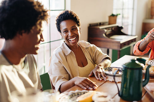 Mother and son sharing laughs at the breakfast table in a Brazilian home