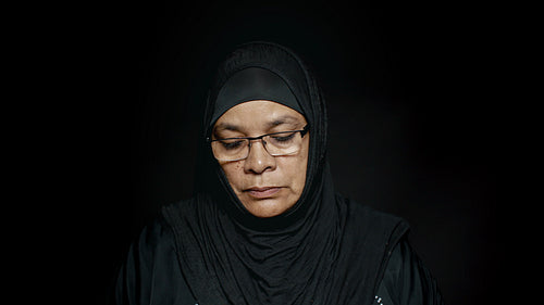  Upset woman in hijab looking at camera