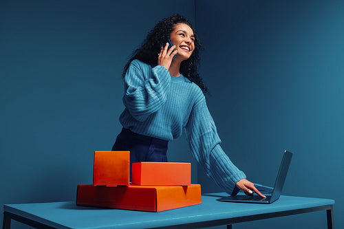 Salesperson talking on phone in monochromatic home office setup
