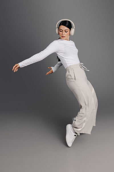 Active young woman doing some dance moves while listening to music