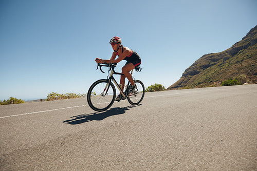 Young woman cycling on the country road