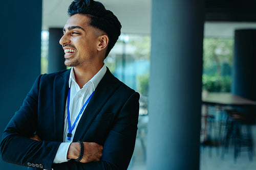 Confident Indian lawyer smiling in a modern office setting