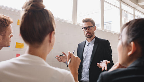 Businesspeople discussing in work in meeting room