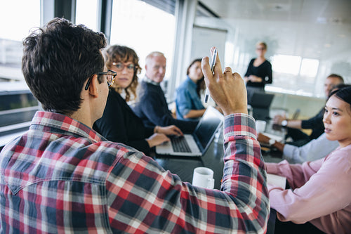 Businessman asking a question in meeting