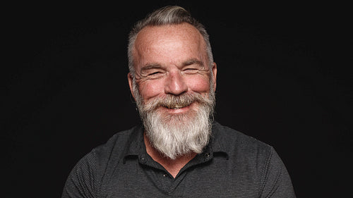 Smiling old man with a beard