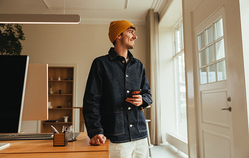 Casual professional standing in a contemporary office