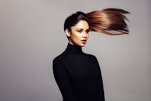 Beautiful woman with hair ponytail flying in air