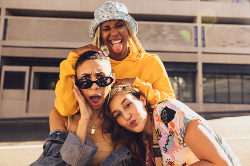Three female friends having fun together outdoors