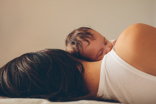 Mother and son sleeping together in bed