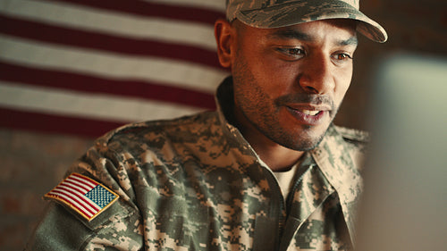 Maintaining long distance relationships in the military: Man in camouflage clothing video calls his loved ones