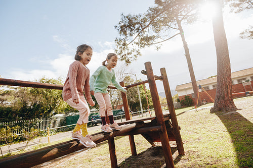 Cute little girls having fun on outdoor playground