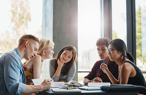Group of students doing school assignment in library