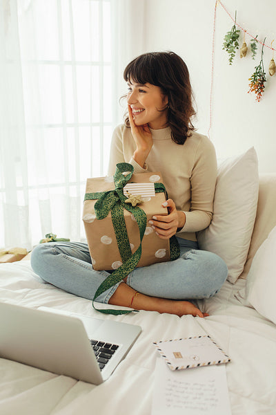 Woman showing christmas present on video call