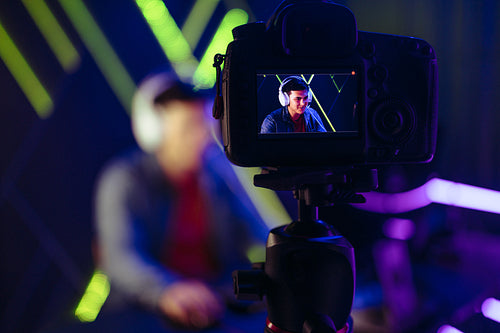 Gamer live streaming himself playing a video game on an online gaming service