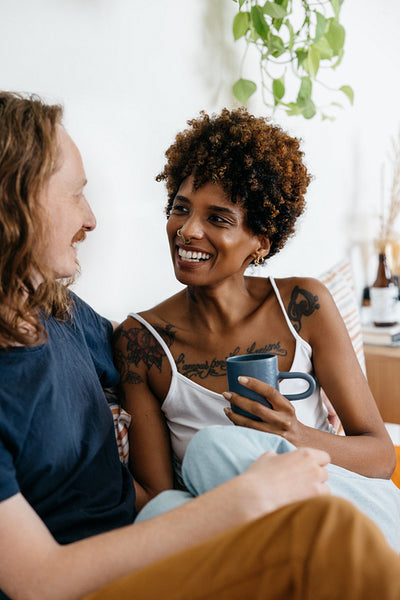 Happy couple enjoying a conversation over coffee at home