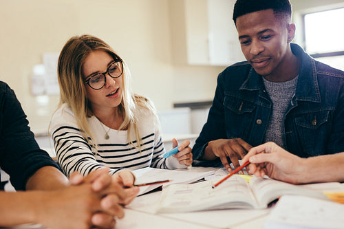 College students studying together in a library