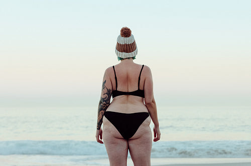 Anonymous winter bather standing at the beach