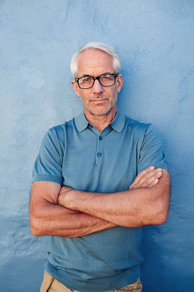 Caucasian man wearing glasses staring at camera