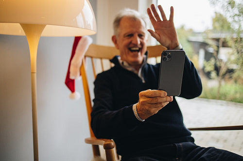 Senior man video calling family on a Christmas day