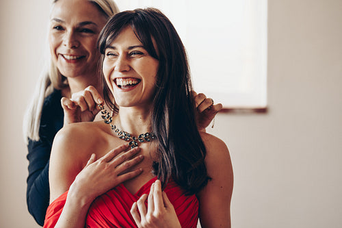 Portrait of smiling mother and daughter dressing up