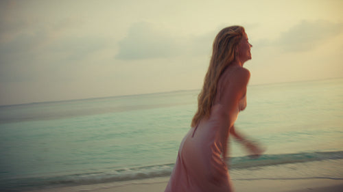 Romantic couple embraces on a pristine beach at sunset during their luxurious tropical resort getaway