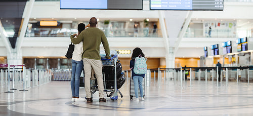 Family waiting for flight at international airport