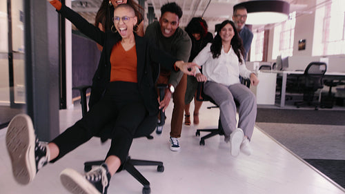 Office Fun: Business people playing with each other, celebrating success