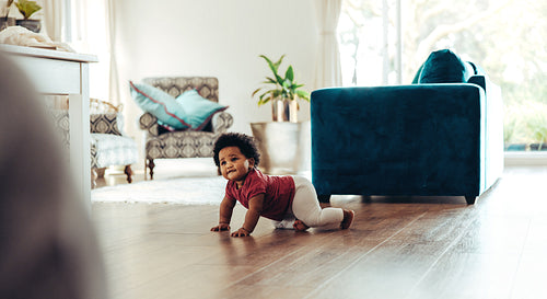 Cute baby crawling on floor
