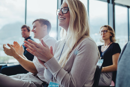 Group of businesspeople clapping hands at seminar