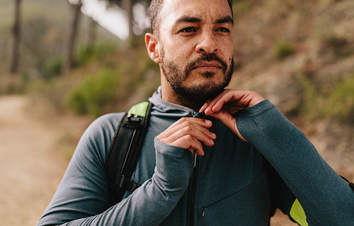 Fit young guy outdoors on mountain trail