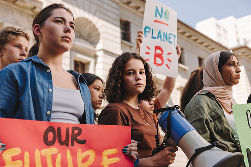 Teenage activist holding a megaphone during a protest