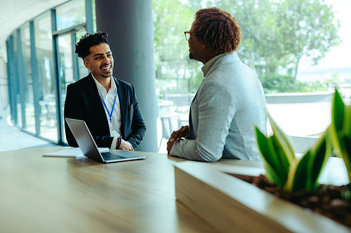 Colleagues chatting at a modern office workspace