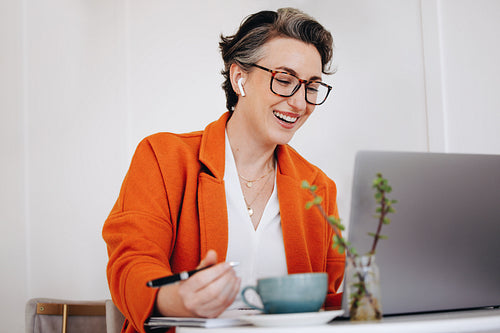 Smiling businesswoman having a virtual meeting while working in a cafe