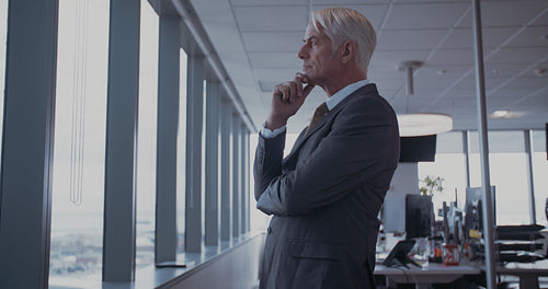 Businessman looking outside the window and thinking
