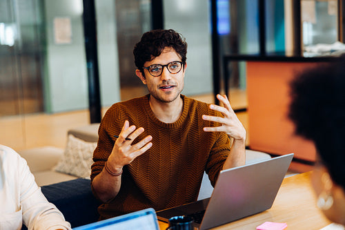 Clarifying the idea: Businessman presenting to colleagues