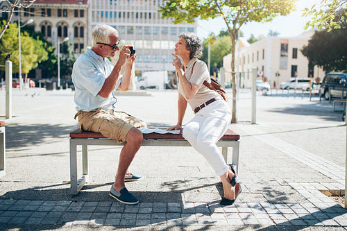 Senior couple taking pictures of each other