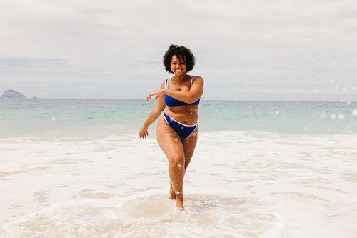 Woman in a bikini having fun during a summer vacation on a beach