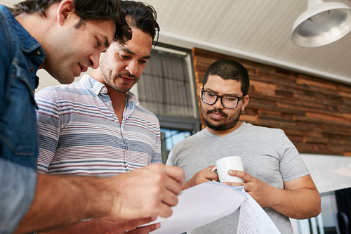 Creative people going through documents in an informal meeting
