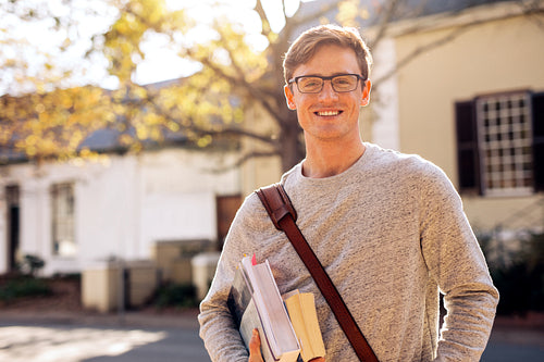 Happy male college student outdoors