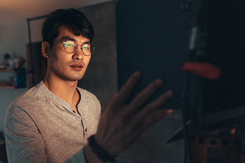 Photographer adjusts lights for the shoot