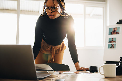 Creative young photographer working in her office