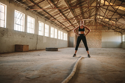Woman taking break after cross training