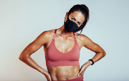 Muscular woman with face mask