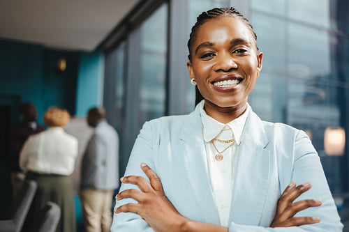 Confident young businesswoman standing in a boardroom meeting